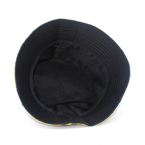 Top view of bucket hat showing the black lining and tropical yellow leaf pattern