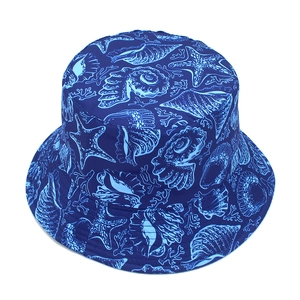 Detailed close-up of dark blue bucket hat with light blue sea life pattern and twill texture
