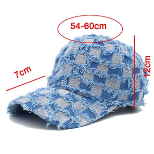 Close-up of blue and white checkered denim baseball cap with frayed fringe details