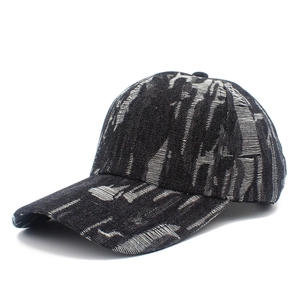 Faded black distressed denim baseball cap with horizontal torn textures and curved brim