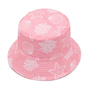 Detail of pink reversible bucket hat with white starfish and coral print patterns