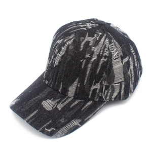 Detailed texture of distressed denim baseball cap with vintage frayed edges and white contrast