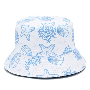 Reversible bucket hat featuring blue starfish and ocean prints on premium white cotton fabric