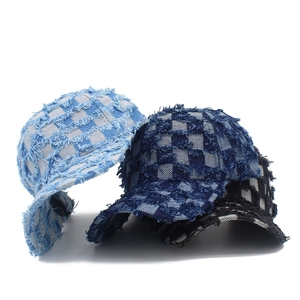 Three distressed denim baseball caps with checkerboard patterns and frayed edge details