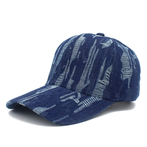 Distressed vintage denim baseball cap with street style graffiti texture in navy blue