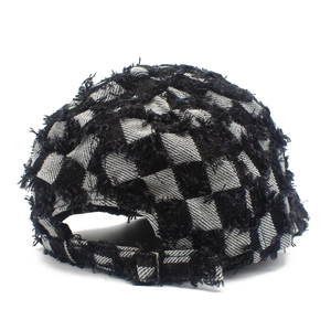 Back view of checkered baseball cap with distressed frayed edges and metal buckle
