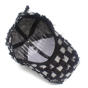 Detail view of checkerboard baseball cap interior with stitching and fraying edges