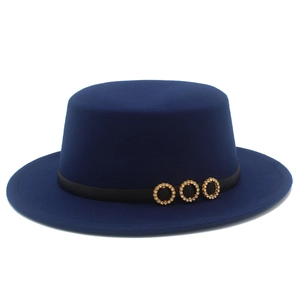 Detail of dark blue boater hat with black ribbon and three gold rhinestone buckles