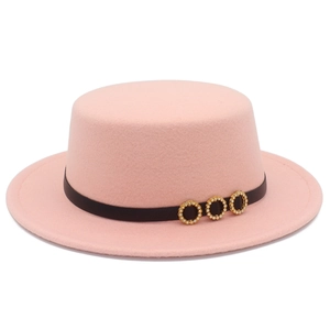 Detail of pink flat-top felt hat with a black band and three gold rhinestone buckles