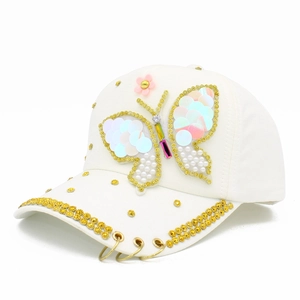 White cotton baseball cap featuring sequin butterfly, pearls and rhinestone accents