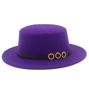 Detail of purple felt boater hat with black band and golden rhinestone ring buckles
