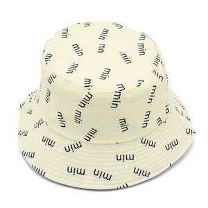 Detailed view of beige bucket hat with repeated min letter print and clean stitching