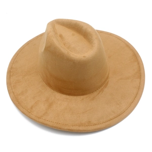 Detailed close-up of camel faux suede fedora hat with wide flat brim and stitching details