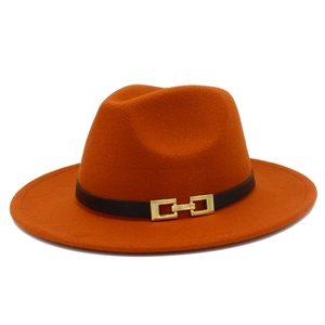 Detailed view of bright orange fedora hat featuring a black leather band and gold buckle
