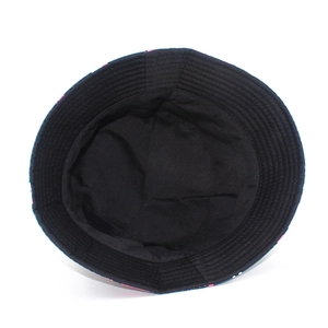Detail of flamingo print bucket hat showing black inner lining and reinforced stitched brim