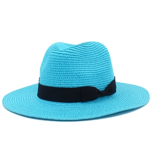 Detail of blue straw sun hat showing fine woven texture and black ribbon with small bow