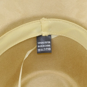 Detail view of the beige suede fedora interior showing the polyester fabric and care label