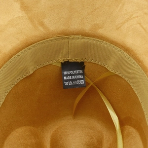 Detail of ginger suede fedora interior showing 100% polyester label and adjustable strap