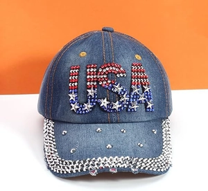 Detailed view of denim baseball cap with rhinestone USA flag letters and metal rivets