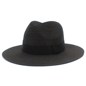Detailed view of the fine woven straw texture and black ribbon trim on this sun hat