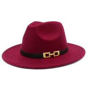 Detailed close-up of a burgundy fedora hat with a black leather band and gold buckle