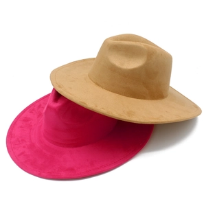Detail showing high-quality camel and magenta suede fedora hats with wide brims on white back