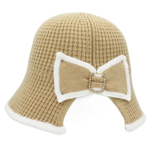 Knitted color-block bucket hat with large bow and rhinestone buckle on white background