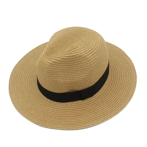 Close-up of fine woven texture and black ribbon detail on a summer straw fedora hat