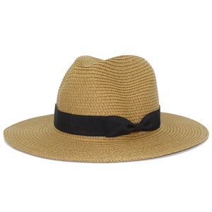 Detailed view of woven straw hat featuring a premium black ribbon and side bow accent
