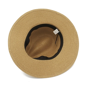 Detail view of woven paper straw sun hat showing interior sweatband and material label
