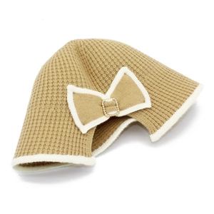 Detail of knit cloche hat featuring large bow with rhinestone buckle and contrast trim