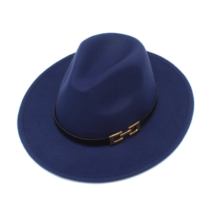 Detail of dark blue wide brim fedora hat with black leather band and gold buckle