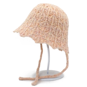 Detailed knit texture of pink winter bucket hat with ear flaps and chin straps