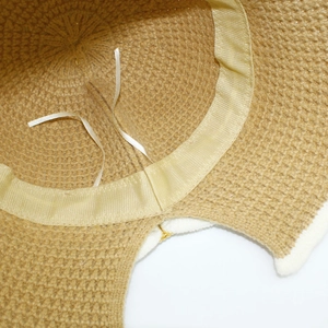 Detailed view of the internal sweatband and adjustable ribbon of the khaki knit bucket hat