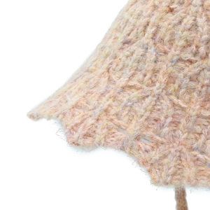 Close-up of chunky knit fabric texture featuring multi-color pastel yarn and soft weave