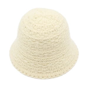 Close-up of cream knitted bucket hat showing detailed thick yarn texture and warm winter weave
