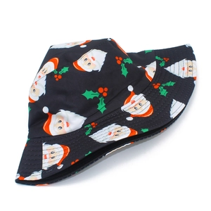 Close-up of black festive bucket hat with Santa Claus and holly berry print details