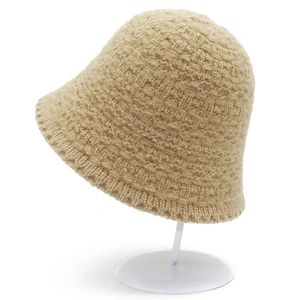 Detailed close-up of khaki knitted bucket hat showing thick woven texture on stand