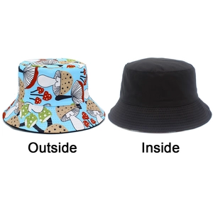 Detailed view of reversible bucket hat showing colorful mushroom print and solid black side