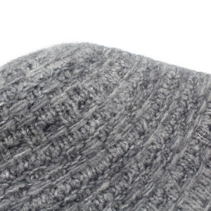 Close-up of grey knitted fisherman hat showing thick wool texture and crochet patterns