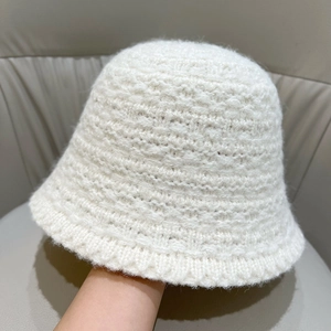 Close-up of white knitted bucket hat showing soft mohair texture and crochet weave details