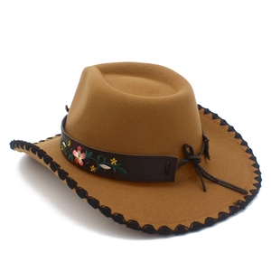 Detail of western cowboy hat featuring floral embroidery on a dark brown leather band