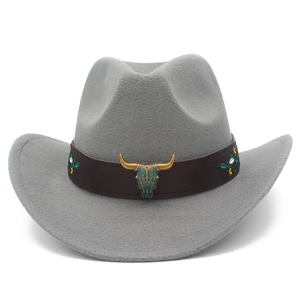 Detail of bronze bull skull buckle and floral embroidery on grey felt cowboy hat