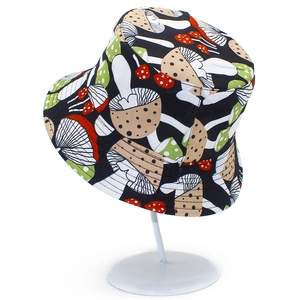 Detail showing colorful mushroom pattern on cotton bucket hat on a metal stand