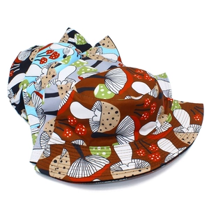 Detail showing colorful mushroom pattern bucket hats in brown, blue, beige and black