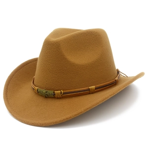 Camel wool felt fedora cowboy hat with pirate skull leather band in a minimalist studio shot