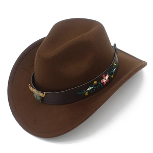 Close-up of brown wool western cowboy hat with floral embroidery and bull head badge