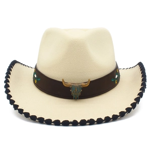 Detailed close-up of ivory cowboy hat with bull skull metal emblem and floral embroidery