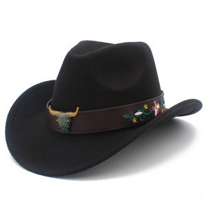 Close-up of western fedora with floral embroidered leather band and bronze bull head ornament