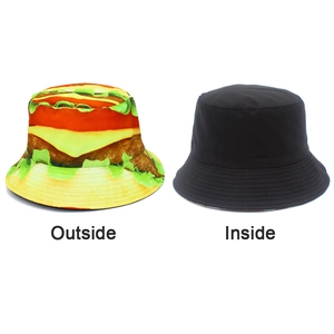 Detail of reversible bucket hat showing vivid hamburger print and plain black lining